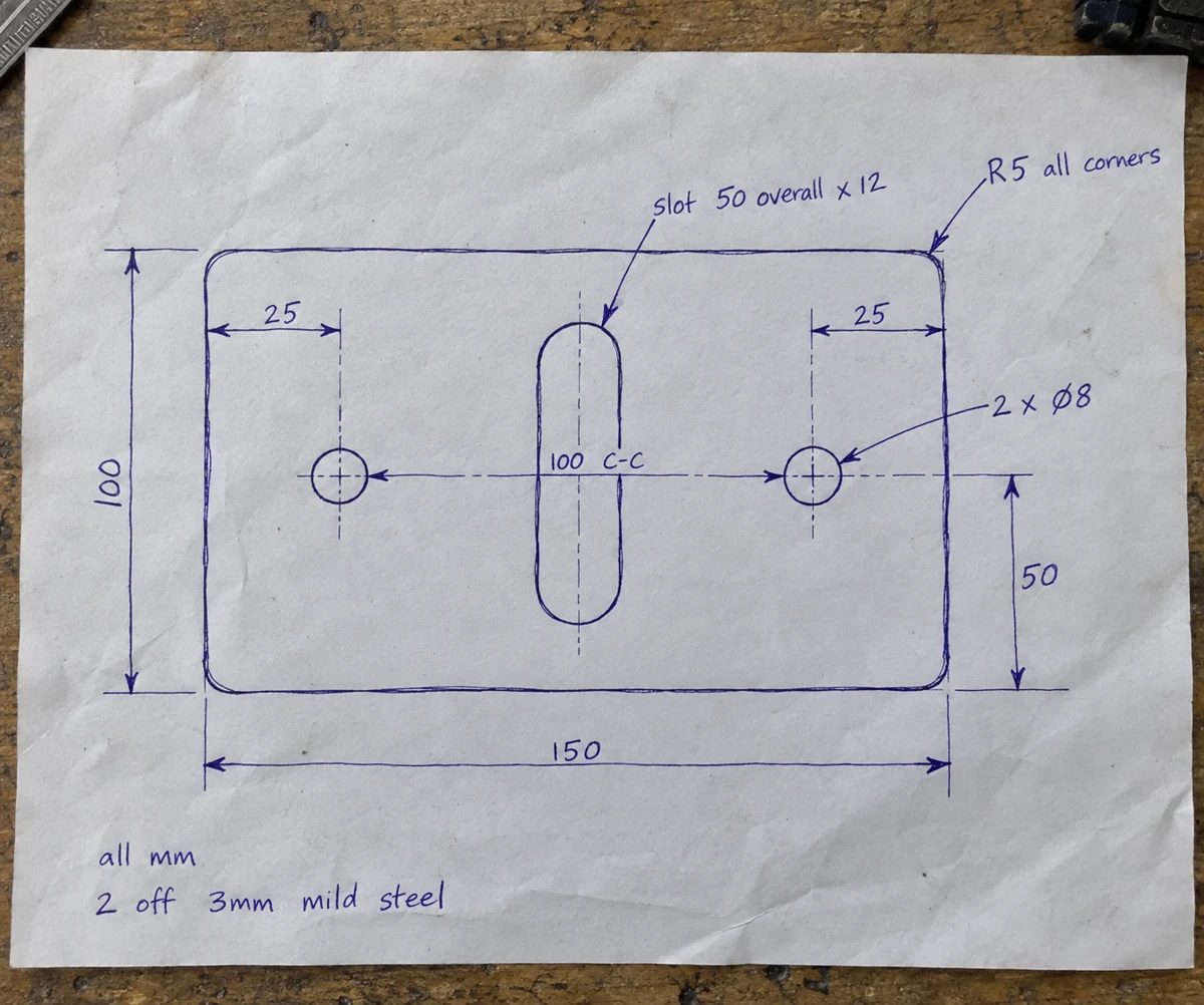A handwritten dimensioned slotted plate on paper
