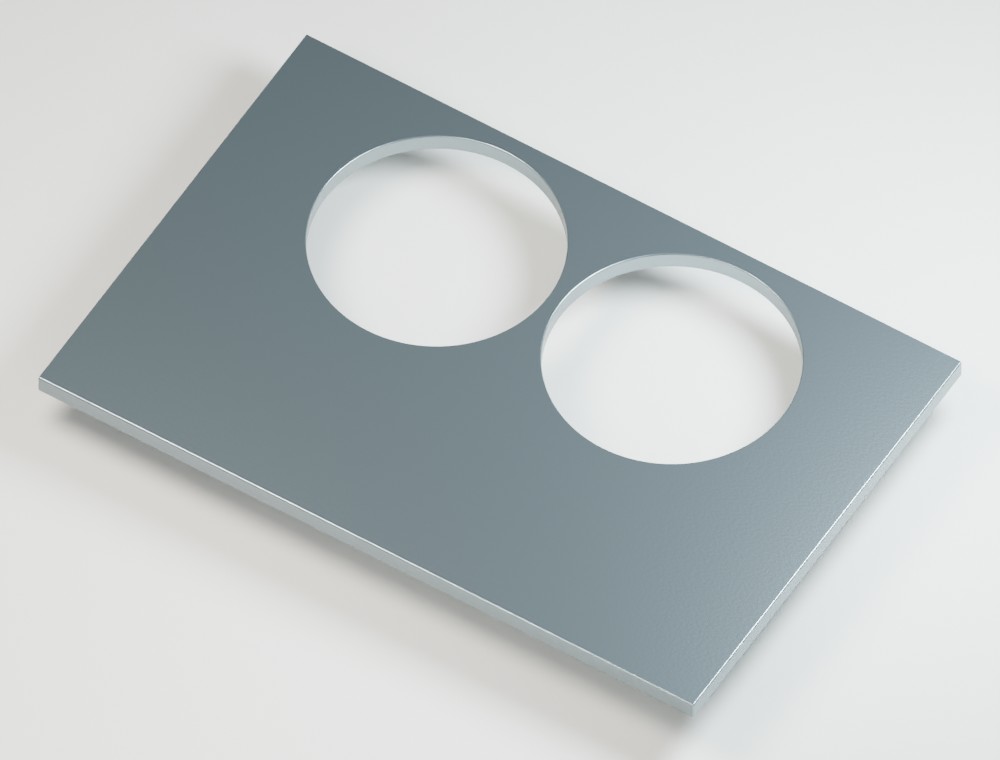 Two large holes nearly touch each other and the outer edge, leaving very thin strips of metal
